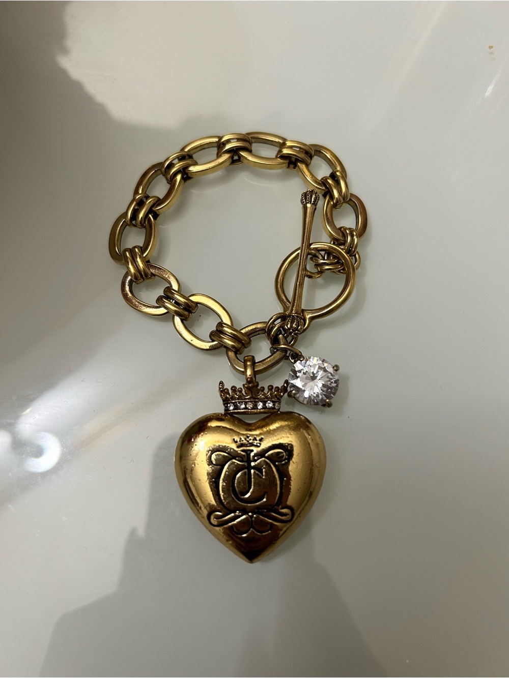 Juicy Couture Gold Heart Charm Bracelet with Crown and Crystal Accent